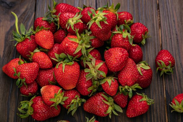 Fresh berries freshly harvested on the farm are on a wooden table