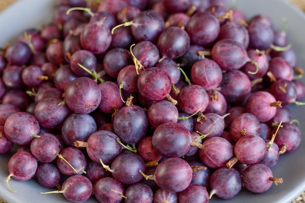 Fresh berries of gooseberry on a plate. It can be used as a background