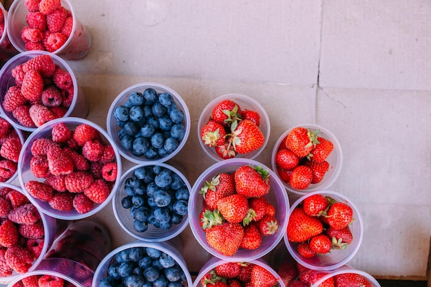 Fresh berries on the market ripe beautiful berries in boxes