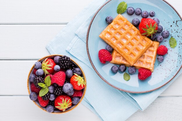 Fresh berries salad in a plate on a  wooden  