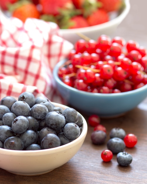 Fresh berries with a napkin on a wooden table close up