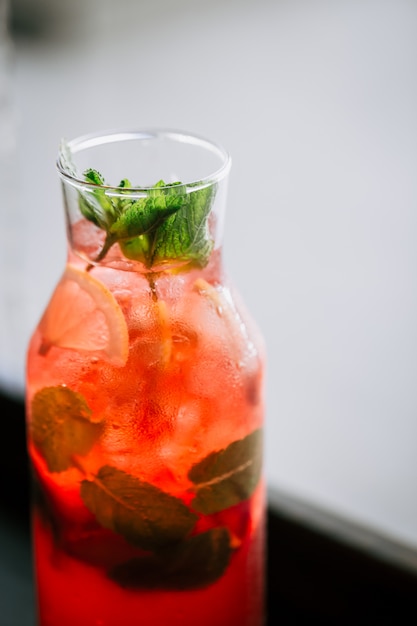 Fresh berry lemonade in a glass jar with mint