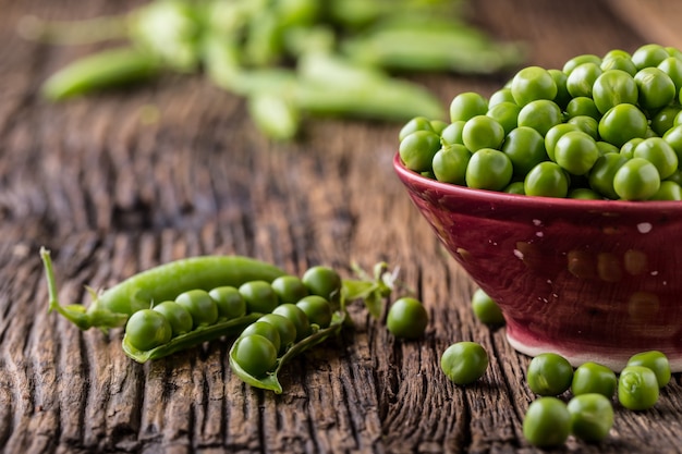 Fresh bio homemade peas and pods on old oak board Healthy fresh green vegetable  peas and pods