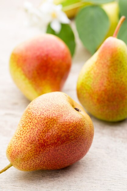 Fresh bio ripe organic pears on rustic wooden table.