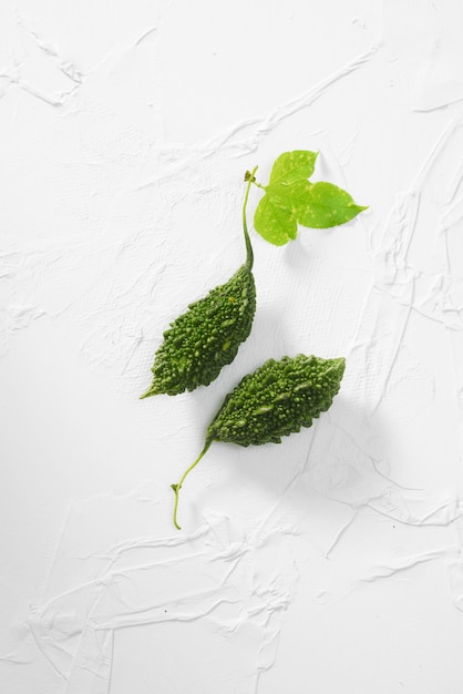 Fresh bitter gourd vegetable on a concrete table