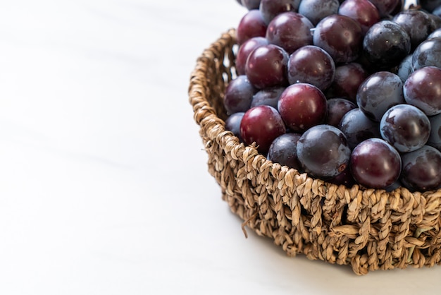 fresh black grapes on white background