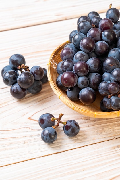 fresh black grapes on white background