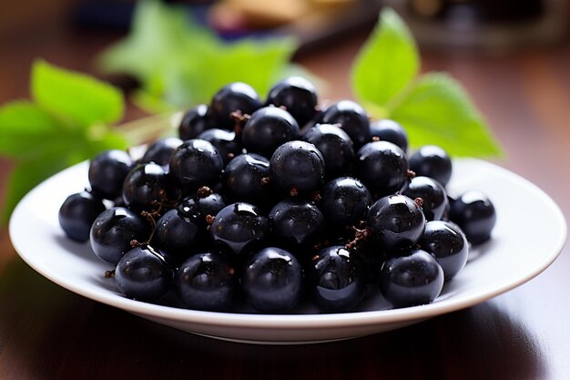 Fresh black grapes on white plate