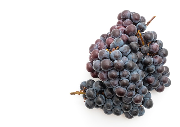 fresh black grapes on white table