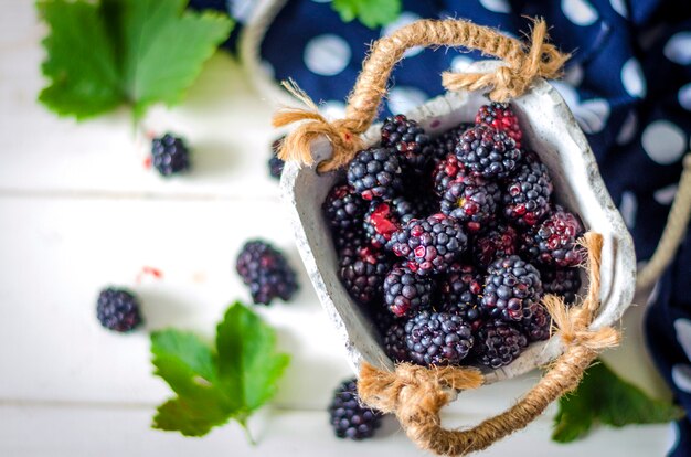 Fresh blackberry in a basket on a table