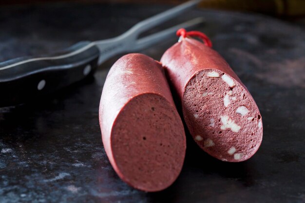 Fresh blood sausage on dark background