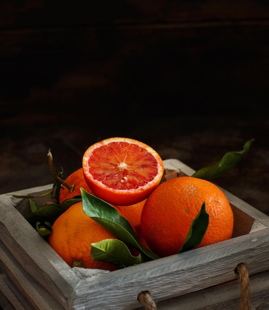 Fresh bloody  oranges with leaves in a box