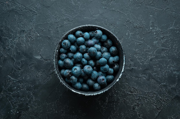 Fresh blueberries on a black stone background Free copy space