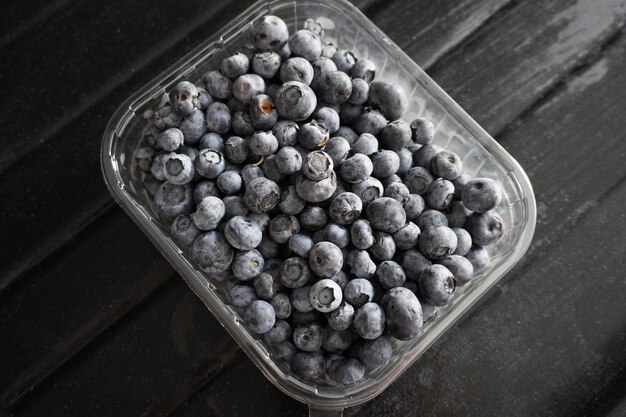 Fresh Blueberries in a bowl on dark background