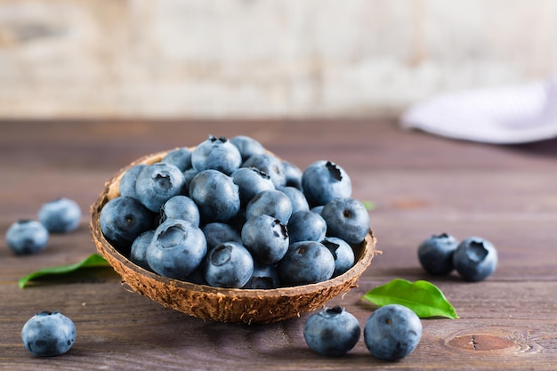 Fresh blueberries in a bowl on a wooden table Organic Wild Superfood