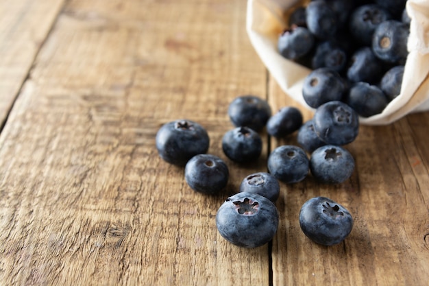 Fresh blueberries, close up on rustic wooden surface. Healthy eating and nutrition.