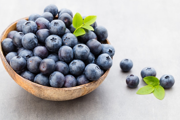 Fresh blueberries natural coconut in a bowl on a gray tabletable