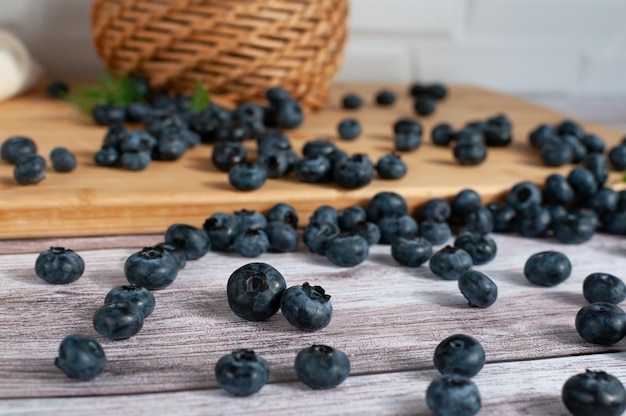 Fresh blueberries scattered on a wooden surface selective focus