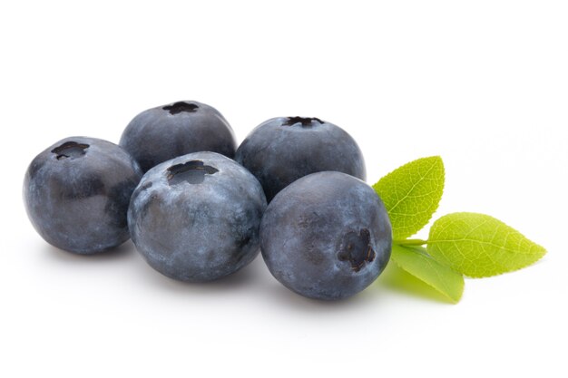 Fresh blueberries on a white surface.