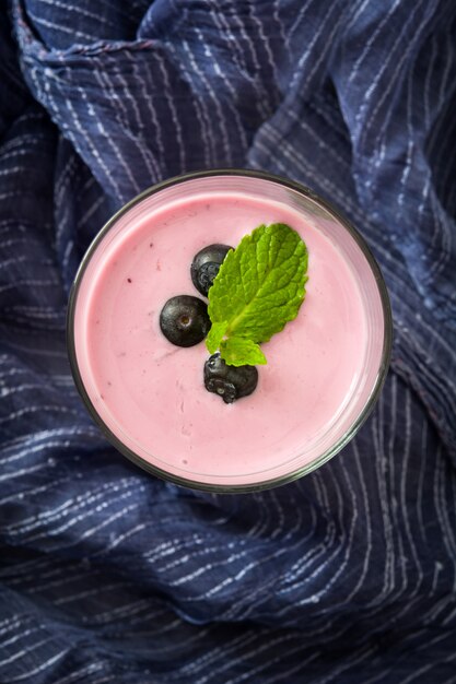 Fresh blueberry smoothie in glass top view