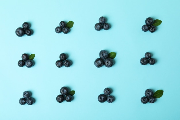 Fresh blueberry with leaves on blue