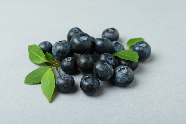 Fresh blueberry with leaves on gray