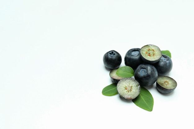 Fresh blueberry with leaves on white surface