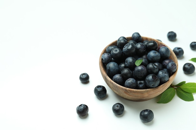 Fresh blueberry with leaves on white