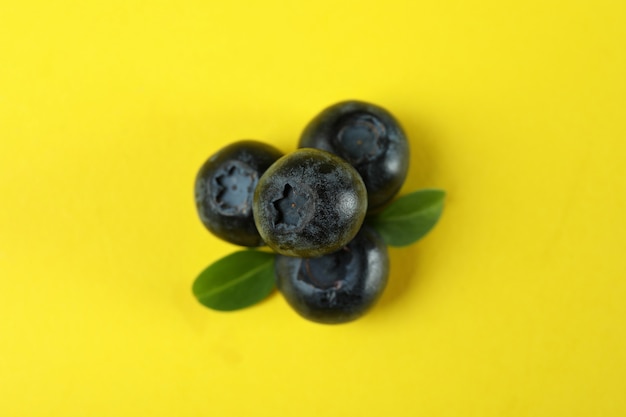 Fresh blueberry with leaves on yellow