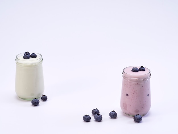 Fresh blueberry yogurt glass on a white background