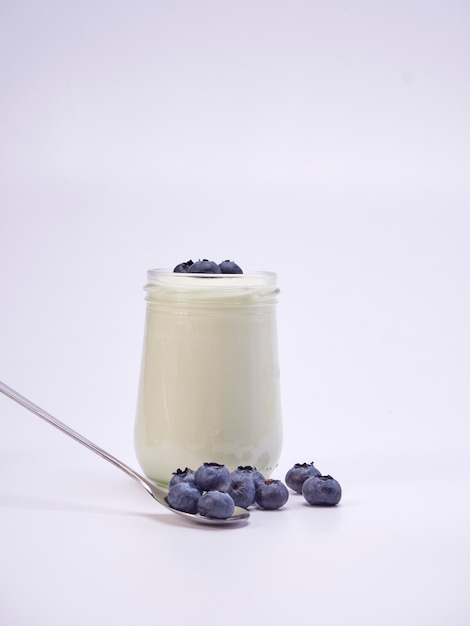 Fresh blueberry yogurt glass on a white background