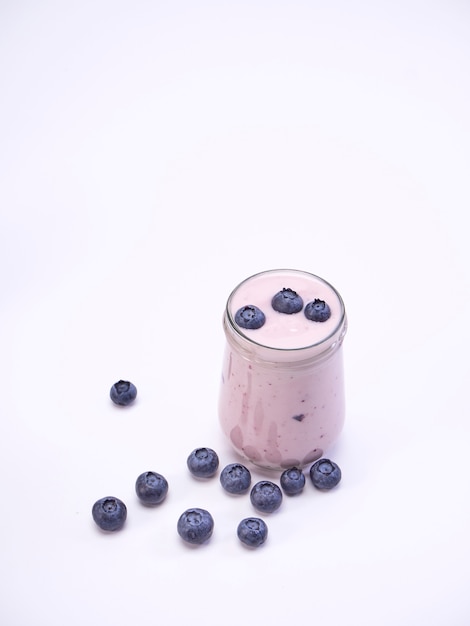 Fresh blueberry yogurt glass on a white background