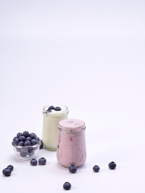 Fresh blueberry yogurt glass on white