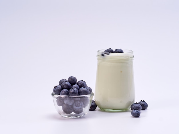 Fresh blueberry yogurt glass on white