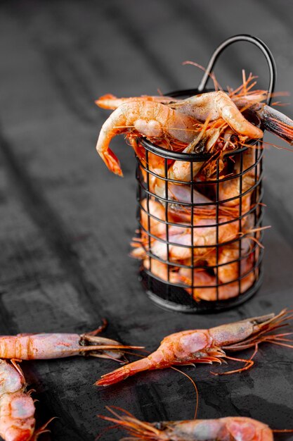 Fresh boiled red shrimps on metal dark background