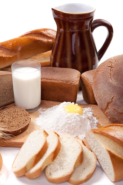 Fresh bread bakery products with eggs and flour on the breadboard