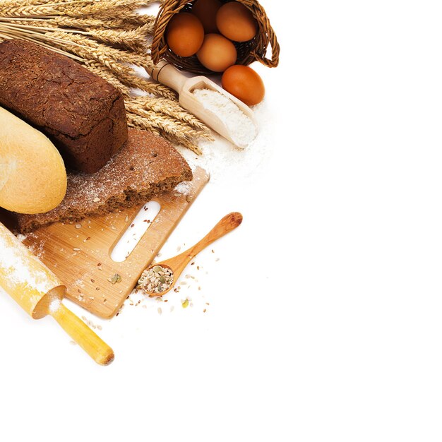 Fresh bread on cutting board isolated over white