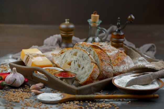 Fresh bread on an old background with kitchen accessories on the table