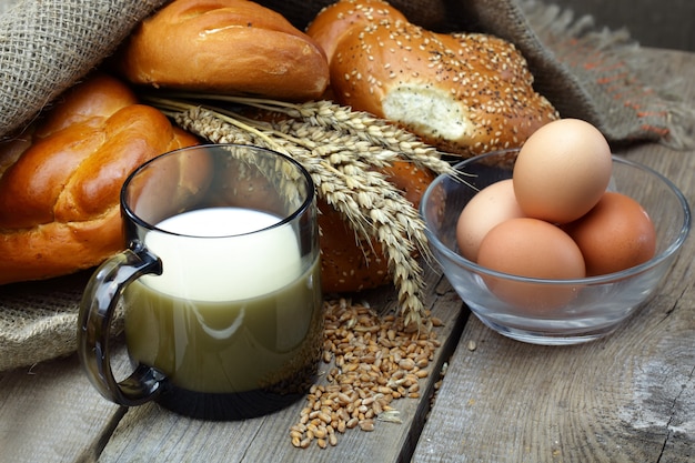 Fresh bread on an old background with kitchen accessories on the table.