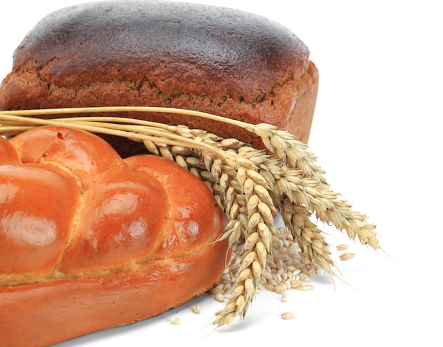 Fresh bread on an old background with kitchen accessories on the table.