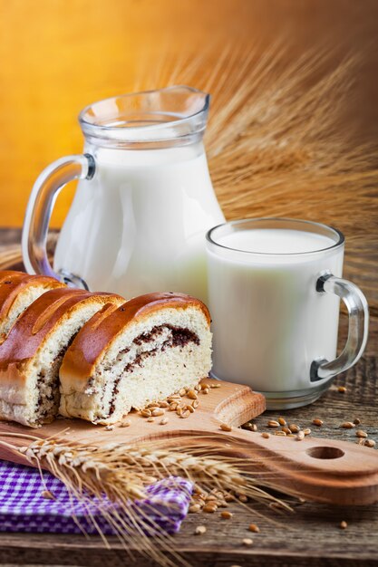 Fresh bread on an old background with kitchen accessories on the table