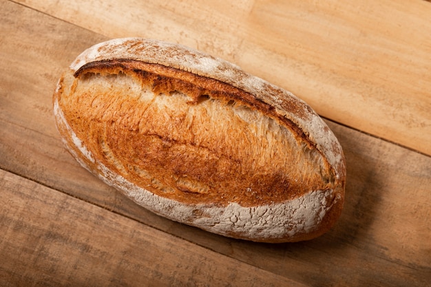 Fresh bread on an old vintage wooden plank table. 