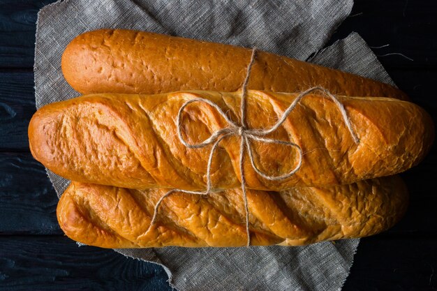 Fresh bread tied a bow on a black 