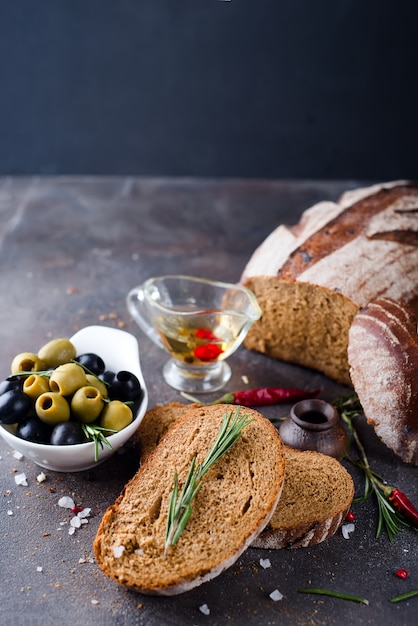 Fresh bread with olive oil and olives