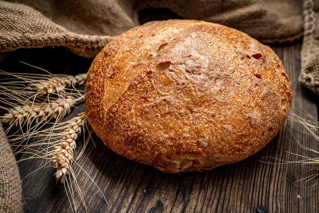 Fresh bread on wooden ground. Freshly baked traditional bread on wooden table. Healthy food