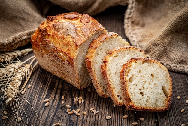 Fresh bread on wooden ground. Freshly baked traditional bread on wooden table. Healthy food