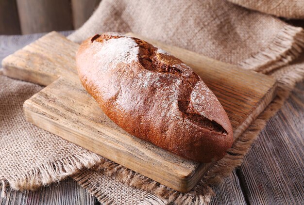 Fresh bread on wooden table close up