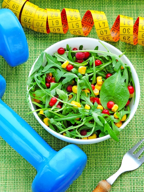 Fresh bright fitness salad with arugula, corn and cranberries