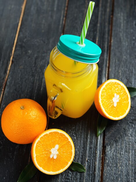 Fresh bright homemade orange juice on wooden table close up