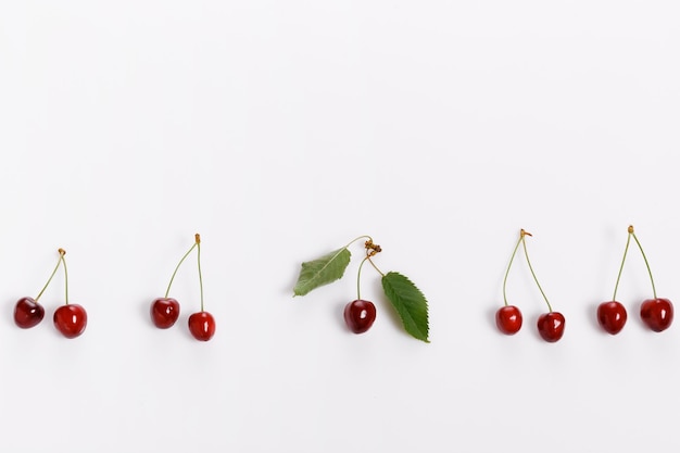 Fresh bright juicy cherries on a white background minimalistic composition minimal theme